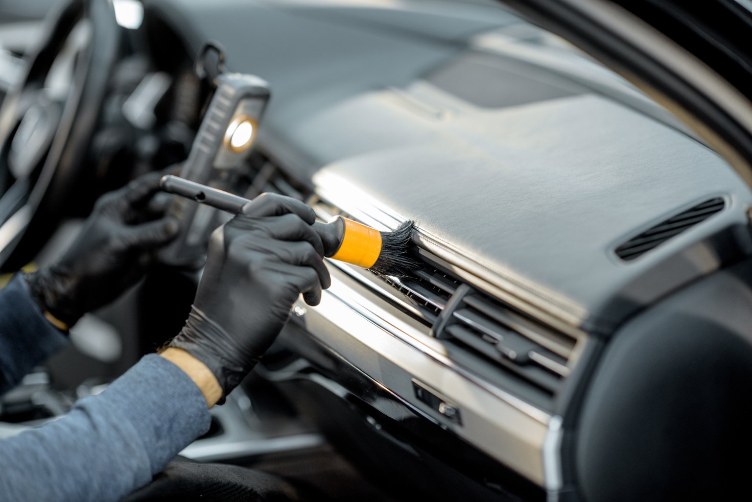 Worker Provides Professional Car Interior Cleaning